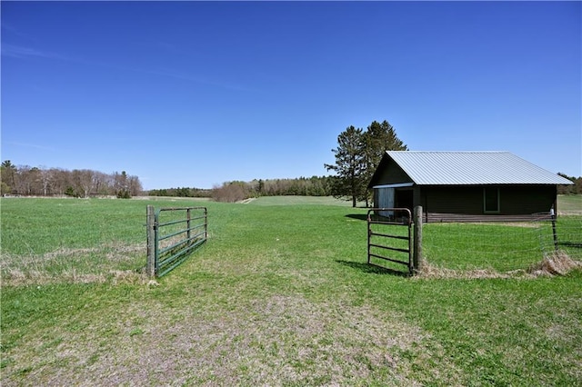 12642 Paddock Rd, Hayward, WI 54843 - view of yard featuring a rural view, an outdoor structure, and a pole building