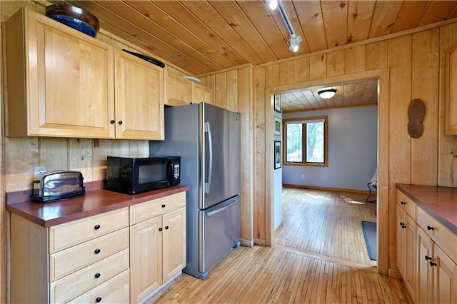 12642 Paddock Rd, Hayward, WI 54843 - kitchen with black microwave, dark countertops, wood ceiling, light brown cabinets, and light wood-style floors