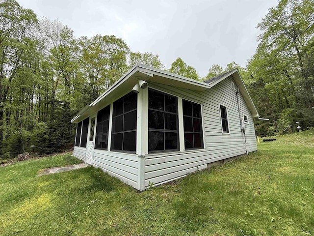 W10550 Hazelgreen Rd, Deerbrook, WI 54424 - view of side of home with a sunroom and a yard
