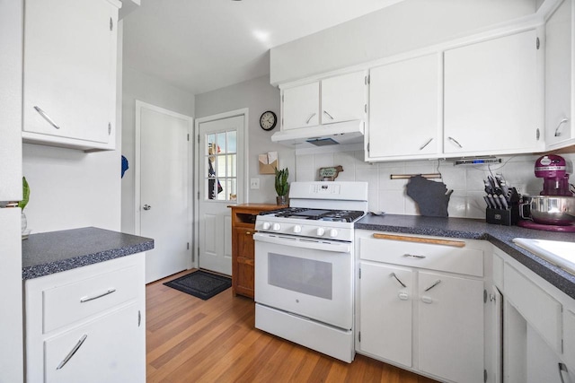 N2356 County Road D Ft, Atkinson, WI 53538 - kitchen featuring gas range gas stove, under cabinet range hood, tasteful backsplash, light wood-style flooring, and white cabinets