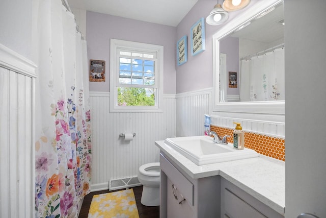 N2356 County Road D Ft, Atkinson, WI 53538 - bathroom with a wainscoted wall, vanity, toilet, and wood finished floors