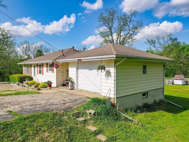 N2356 County Road D Ft, Atkinson, WI 53538 - view of front of home with asphalt driveway, a front yard, and a garage