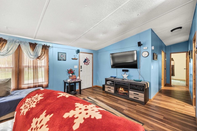 7244 Pine Tree Dr, Almond, WI 54909 - bedroom featuring lofted ceiling, wood finished floors, baseboards, and a textured ceiling