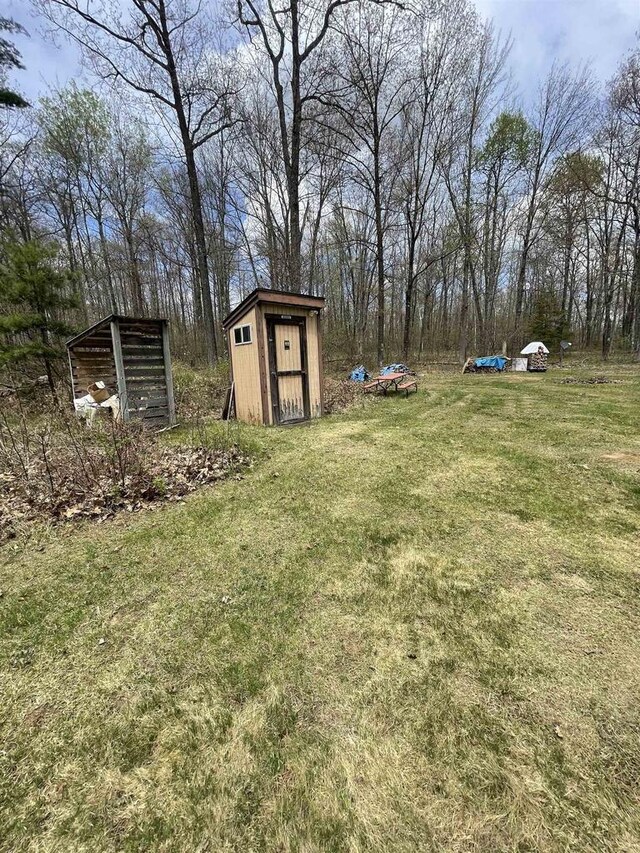 N18355 Big Bear Rd, Pembine, WI 54156 - view of grassy yard featuring a storage unit and an outdoor structure