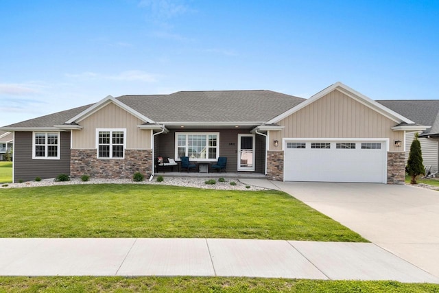 3410 Tulip Trl, Appleton, WI 54913 - craftsman-style home featuring stone siding, a garage, a front yard, concrete driveway, and board and batten siding