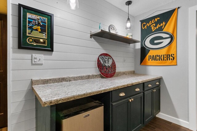 3410 Tulip Trl, Appleton, WI 54913 - detailed view of wood finished floors, baseboards, fridge, and wood walls