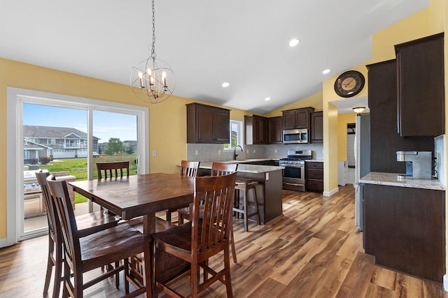 3410 Tulip Trl, Appleton, WI 54913 - dining room featuring wood finished floors, a chandelier, lofted ceiling, and recessed lighting