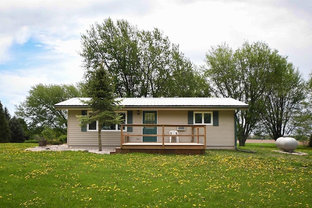 W13414 Liner Rd, Brandon, WI 53919 - view of front of property featuring a front lawn, metal roof, and a wooden deck