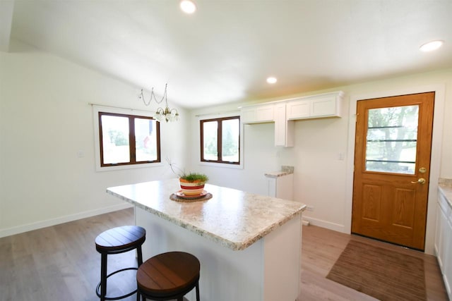 W13414 Liner Rd, Brandon, WI 53919 - kitchen with a center island, white cabinetry, light wood-style floors, a kitchen bar, and recessed lighting