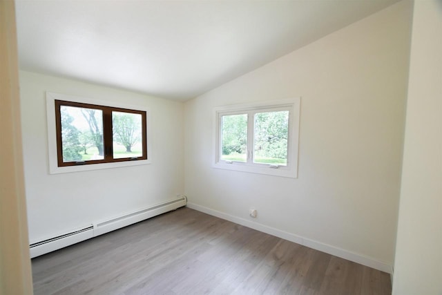 W13414 Liner Rd, Brandon, WI 53919 - spare room featuring a baseboard heating unit, vaulted ceiling, light wood-style floors, and baseboards