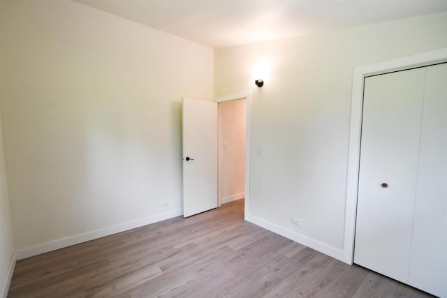 W13414 Liner Rd, Brandon, WI 53919 - unfurnished bedroom with light wood finished floors, baseboards, and a closet