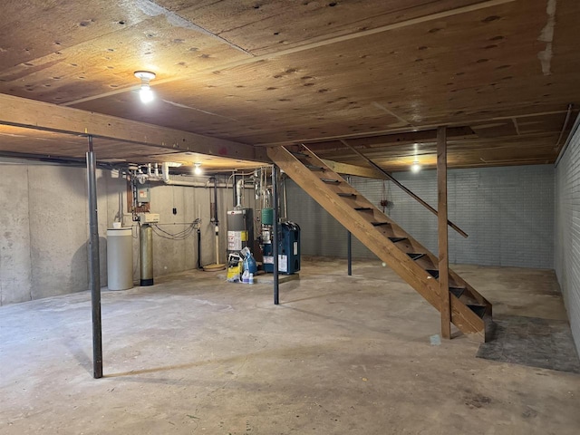 W13414 Liner Rd, Brandon, WI 53919 - unfinished basement with water heater, stairway, a heating unit, and a water softener system
