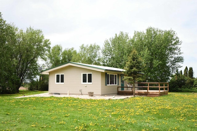 W13414 Liner Rd, Brandon, WI 53919 - rear view of property featuring a deck, a yard, and view of wooded area