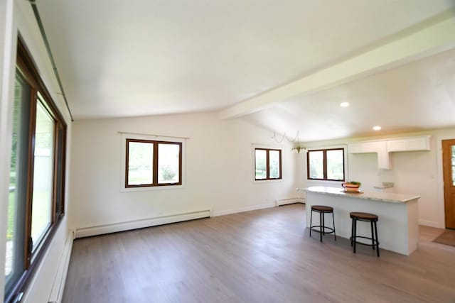 W13414 Liner Rd, Brandon, WI 53919 - kitchen featuring baseboard heating, white cabinets, a kitchen bar, light wood-style floors, and recessed lighting