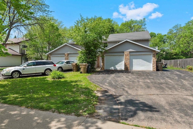 18 Northridge Ter, Madison, WI 53704 - view of front of house with asphalt driveway, brick siding, and an attached garage