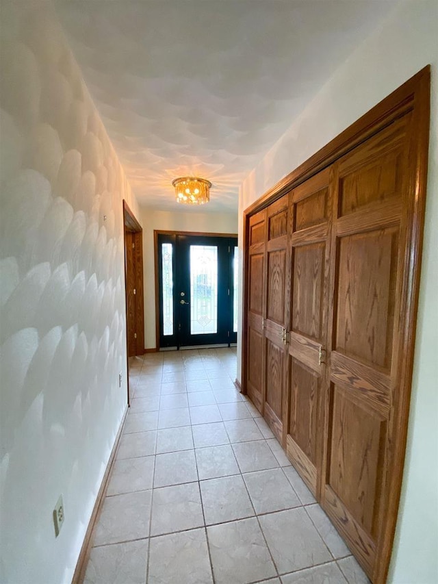 831 County Road Ig, Livingston, WI 53554 - doorway to outside with light tile patterned flooring, baseboards, and a chandelier