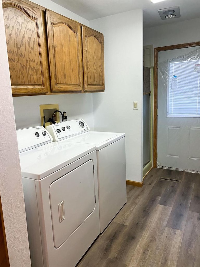 831 County Road Ig, Livingston, WI 53554 - washroom with cabinet space, washing machine and clothes dryer, dark wood finished floors, and baseboards
