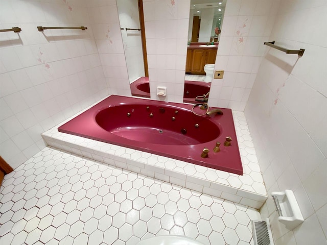 831 County Road Ig, Livingston, WI 53554 - bathroom with tile walls, a tub with jets, vanity, toilet, and tile patterned flooring