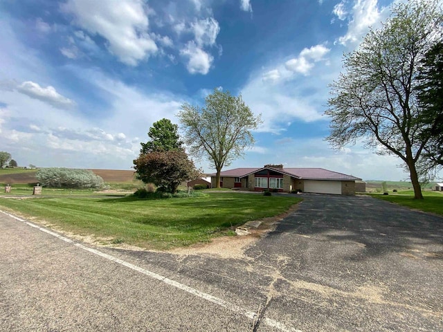 831 County Road Ig, Livingston, WI 53554 - view of front facade featuring an attached garage, a front yard, and driveway