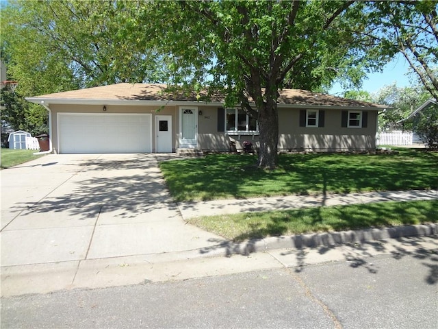 3412 Jill Ave, Eau Claire, WI 54701 - ranch-style home featuring an attached garage, driveway, a shed, and stucco siding