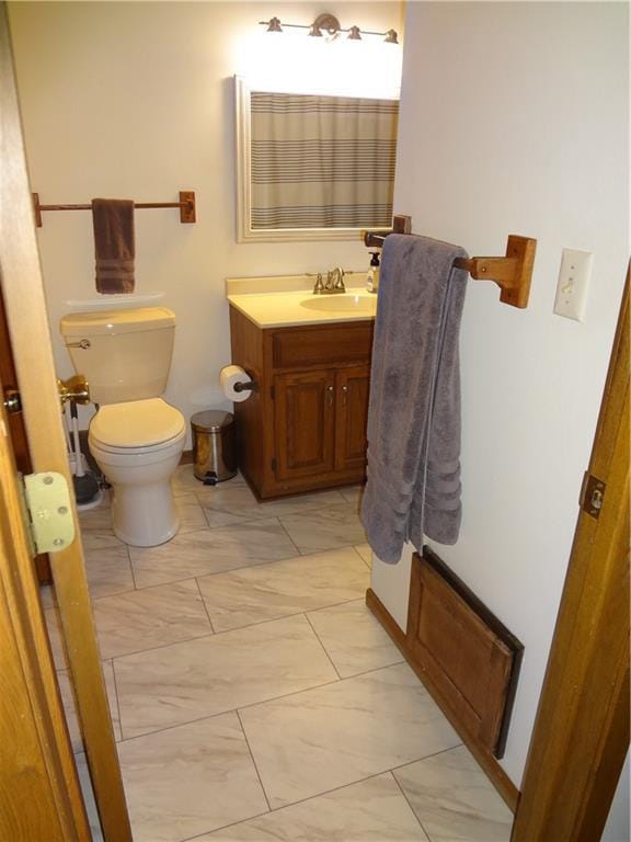 3412 Jill Ave, Eau Claire, WI 54701 - bathroom featuring toilet, vanity, marble look tiles, and a shower with curtain
