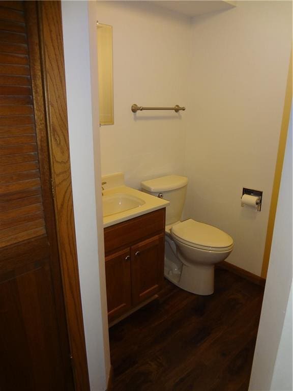 3412 Jill Ave, Eau Claire, WI 54701 - bathroom featuring wood finished floors, toilet, vanity, and baseboards