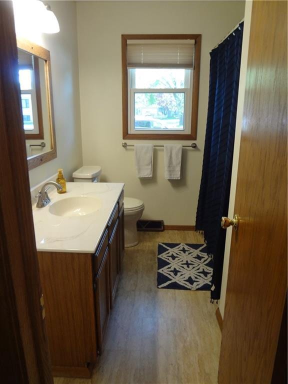 3412 Jill Ave, Eau Claire, WI 54701 - bathroom featuring toilet, healthy amount of natural light, wood finished floors, and vanity