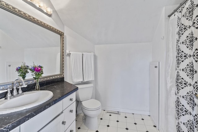 1293 Chesterwood Ln, Pewaukee, WI 53072 - bathroom featuring lofted ceiling, toilet, vanity, and tile patterned floors