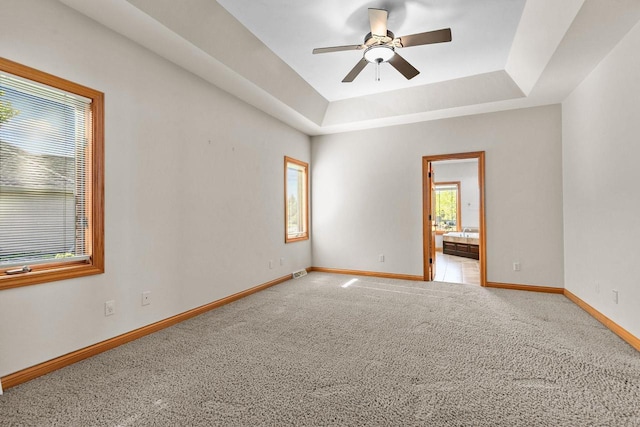 N8454 Muirfield Way, Menasha, WI 54952 - empty room featuring baseboards, ceiling fan, a tray ceiling, and carpet flooring