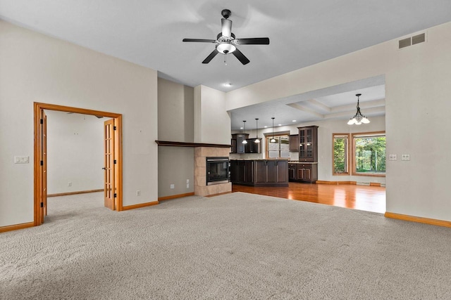 N8454 Muirfield Way, Menasha, WI 54952 - unfurnished living room with carpet floors, baseboards, a ceiling fan, and a tiled fireplace