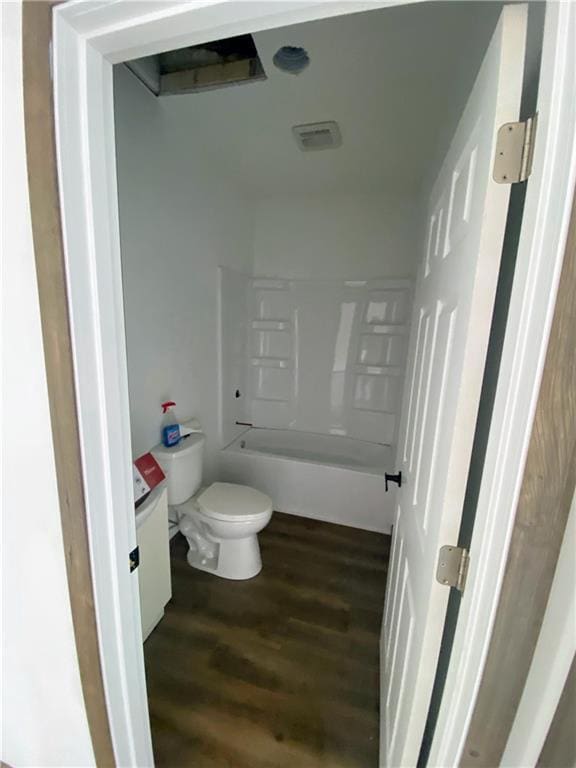 202 Huset Ln, Dallas, WI 54733 - full bath featuring toilet, wood finished floors, vanity, and bathtub / shower combination
