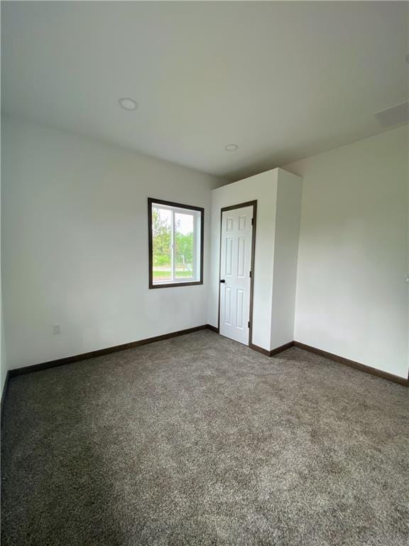 202 Huset Ln, Dallas, WI 54733 - spare room featuring baseboards and dark colored carpet