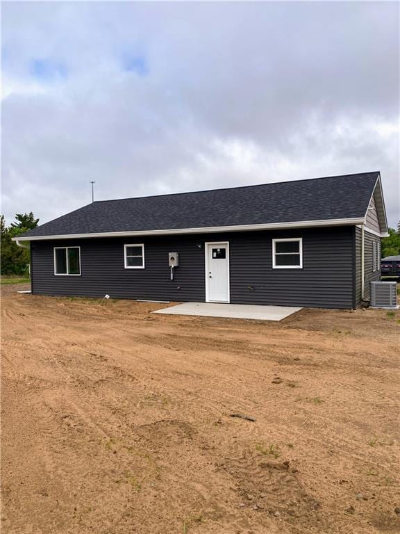 202 Huset Ln, Dallas, WI 54733 - view of front of house with a patio area, central AC unit, and roof with shingles