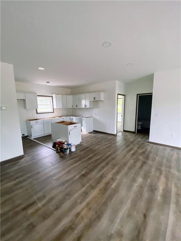 202 Huset Ln, Dallas, WI 54733 - kitchen with white cabinetry, baseboards, and dark wood-style flooring