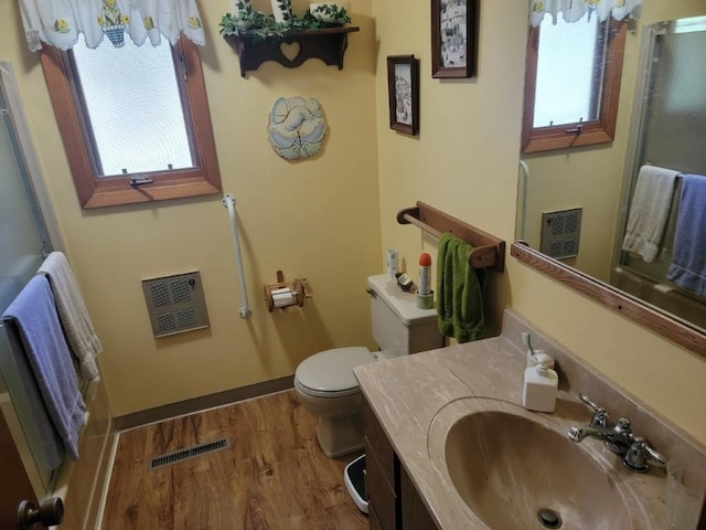 4055W Lester Ln, Loretta, WI 54896 - full bath featuring heating unit, wood finished floors, toilet, an enclosed shower, and vanity