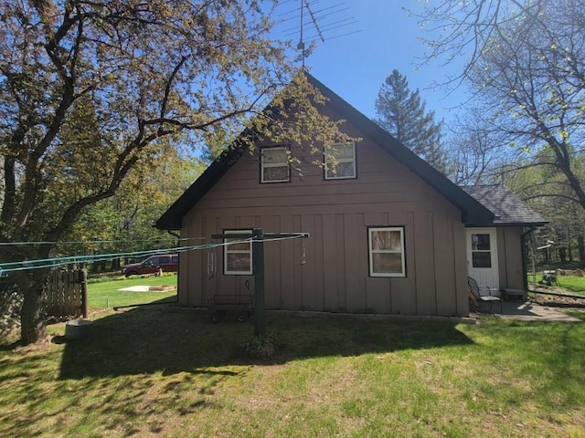 4055W Lester Ln, Loretta, WI 54896 - view of side of home featuring board and batten siding and a lawn
