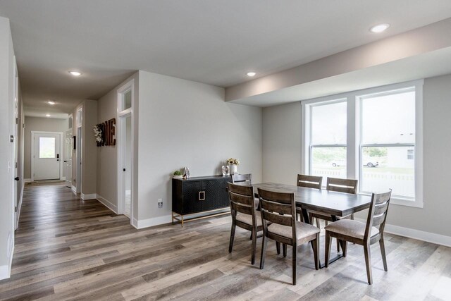 241 E Hubert St, Edgerton, WI 53534 - dining room with healthy amount of natural light, wood finished floors, baseboards, and recessed lighting