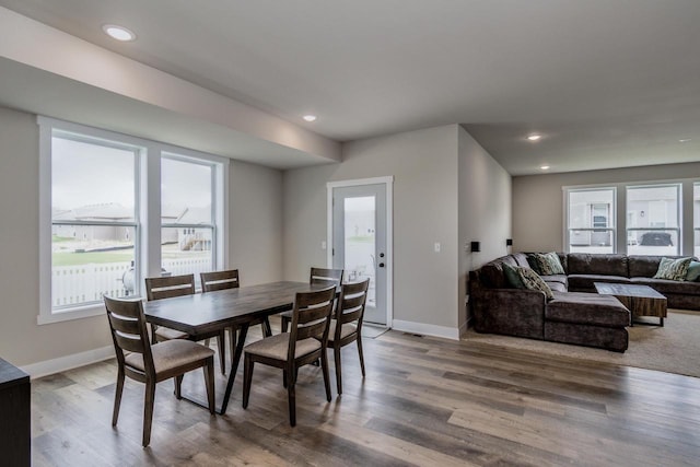 241 E Hubert St, Edgerton, WI 53534 - dining area with healthy amount of natural light, wood finished floors, baseboards, and recessed lighting