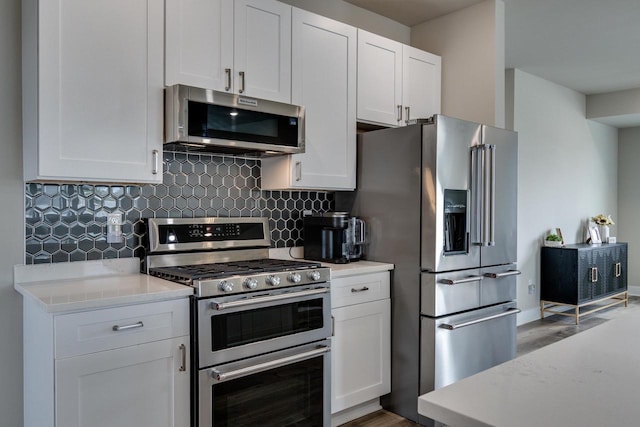 241 E Hubert St, Edgerton, WI 53534 - kitchen with stainless steel appliances, light wood finished floors, tasteful backsplash, and light countertops