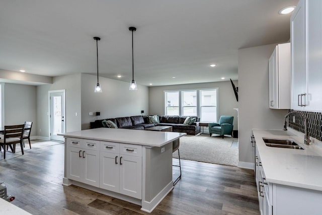 241 E Hubert St, Edgerton, WI 53534 - kitchen featuring a sink, open floor plan, white cabinets, light countertops, and recessed lighting