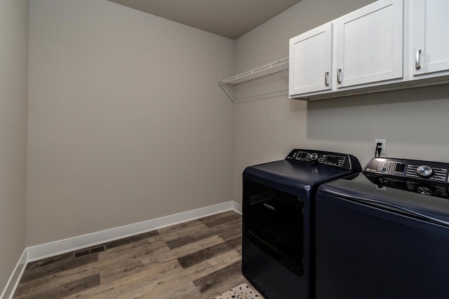 241 E Hubert St, Edgerton, WI 53534 - laundry room with cabinet space, wood finished floors, independent washer and dryer, and baseboards