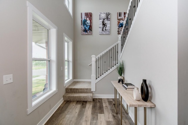 241 E Hubert St, Edgerton, WI 53534 - foyer entrance featuring stairway, wood finished floors, baseboards, and a towering ceiling