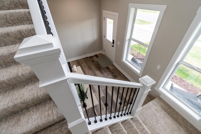 241 E Hubert St, Edgerton, WI 53534 - staircase featuring baseboards and wood finished floors
