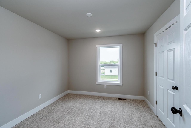 241 E Hubert St, Edgerton, WI 53534 - unfurnished room featuring baseboards, light carpet, and recessed lighting