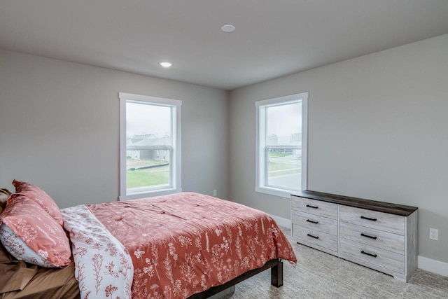 241 E Hubert St, Edgerton, WI 53534 - bedroom featuring multiple windows, light carpet, baseboards, and recessed lighting
