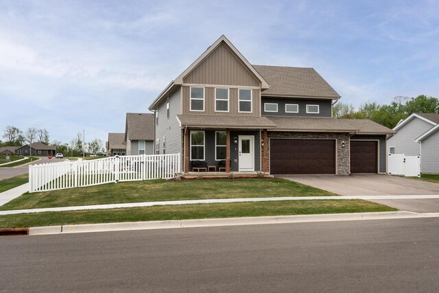 241 E Hubert St, Edgerton, WI 53534 - craftsman inspired home with a porch, concrete driveway, board and batten siding, and an attached garage