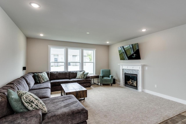 241 E Hubert St, Edgerton, WI 53534 - living room featuring a tiled fireplace, recessed lighting, and baseboards