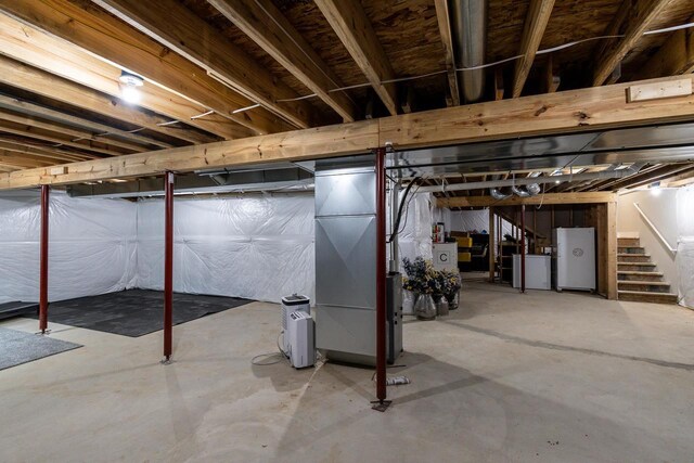 241 E Hubert St, Edgerton, WI 53534 - unfinished basement featuring stairway and freestanding refrigerator