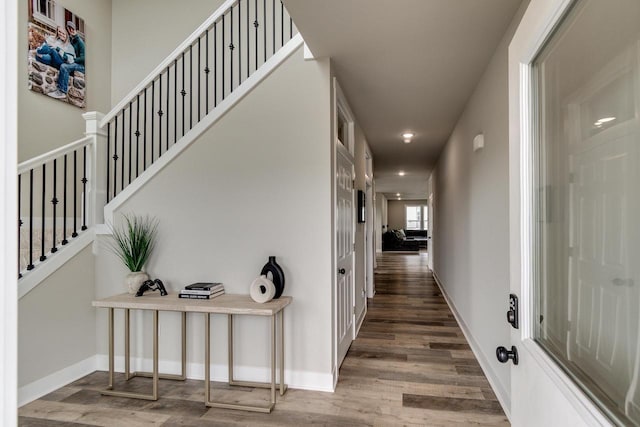 241 E Hubert St, Edgerton, WI 53534 - hall featuring wood finished floors, stairs, recessed lighting, and baseboards