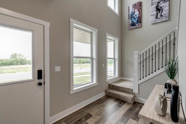 241 E Hubert St, Edgerton, WI 53534 - foyer with stairway, dark wood-style flooring, baseboards, and a high ceiling